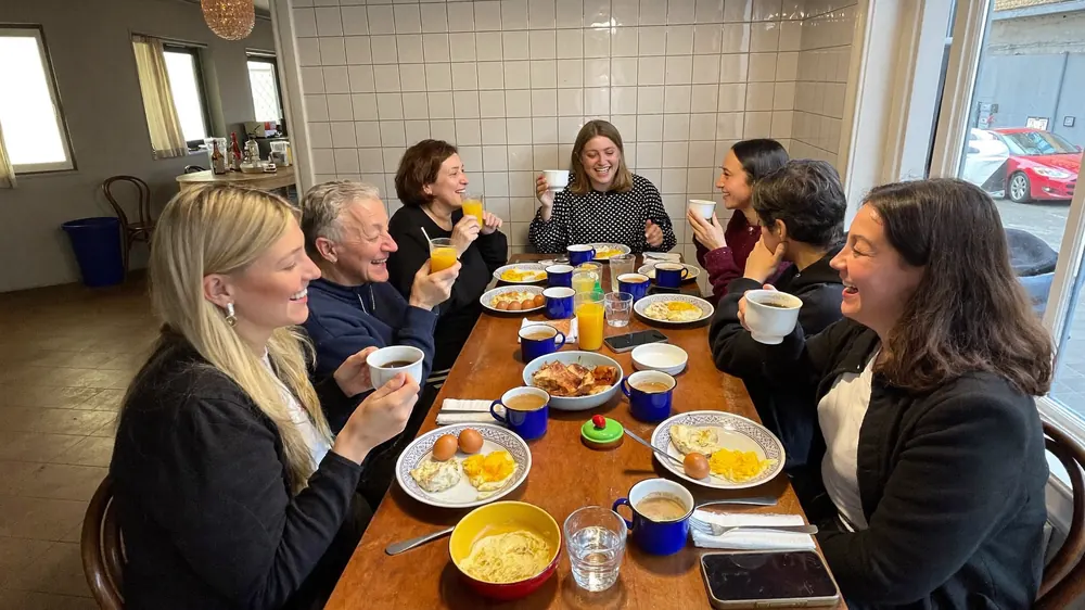 Six friends having brunch at the long table