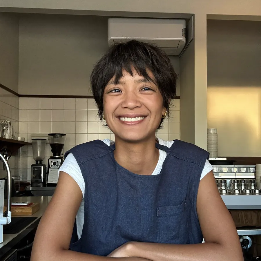 Ivy, the owner, leaning on the counter